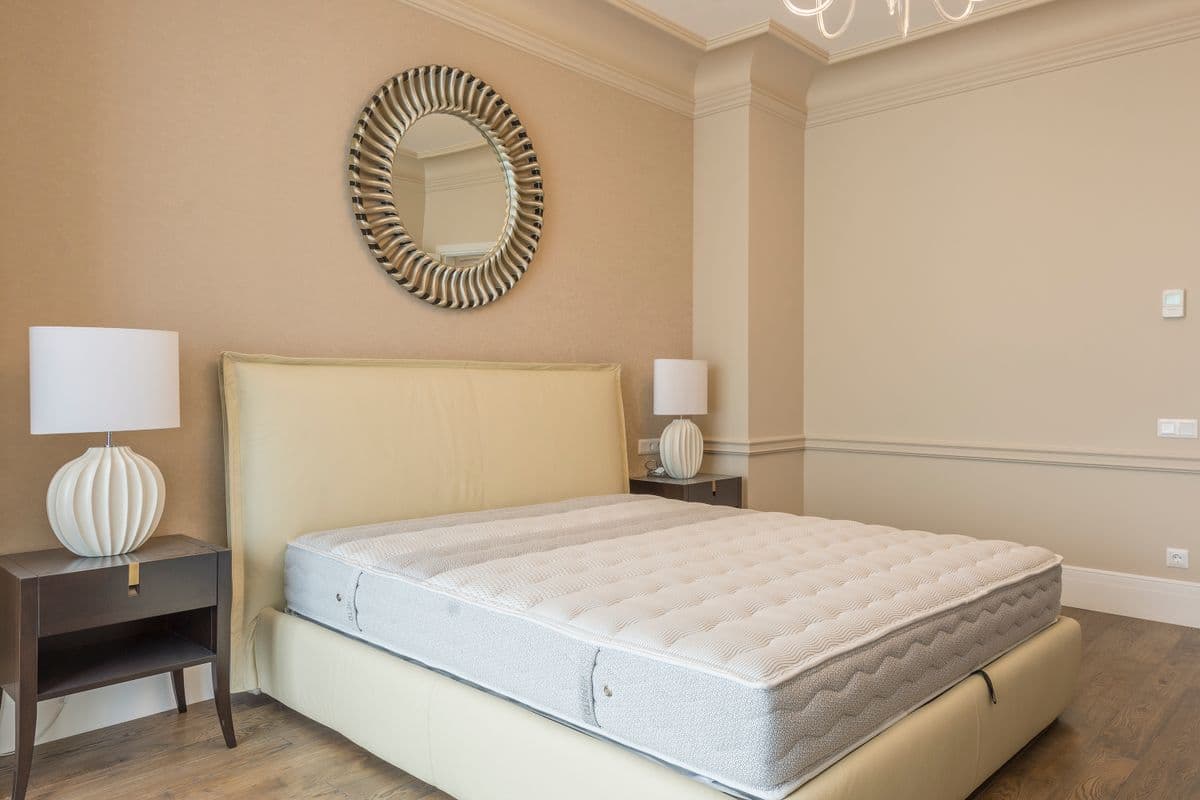 A made bed in a softly lit bedroom